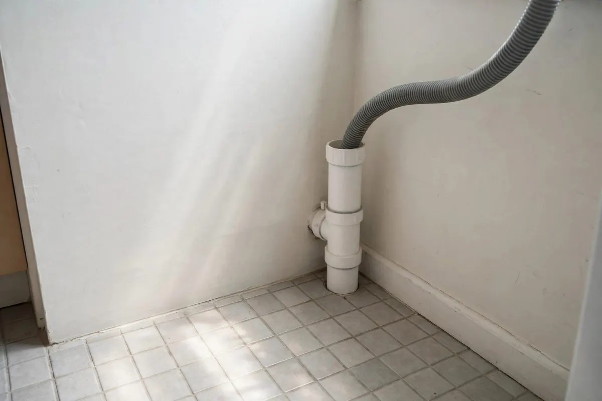 A laundry standpipe with a washer drain hose in a home